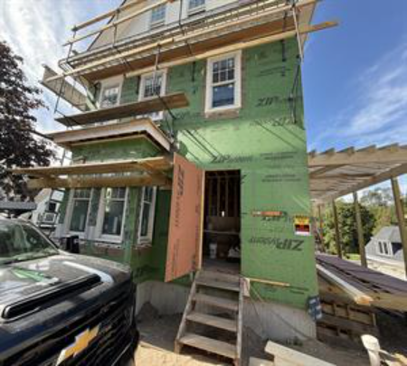 Multi-level scaffolding installed around a Cape Cod home