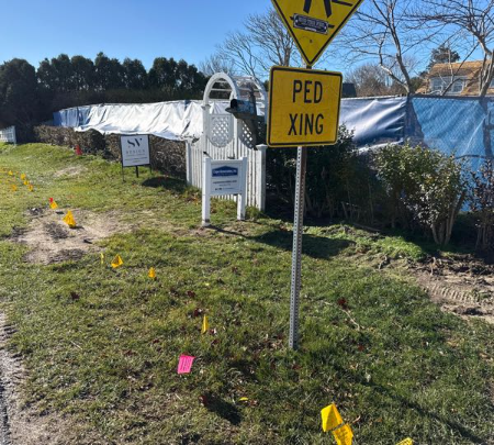 Marked pedestrian controls beside an active construction area