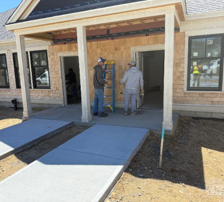 Workers discussing work at an active Cape Cod construction site